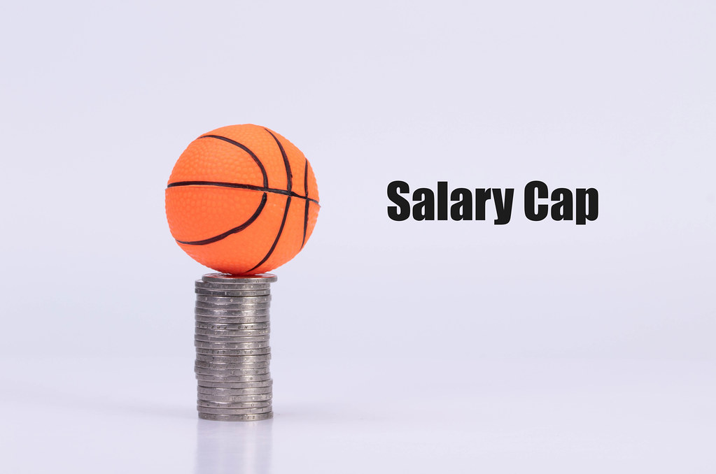 Basketball ball on coinstack with Salary Cap text