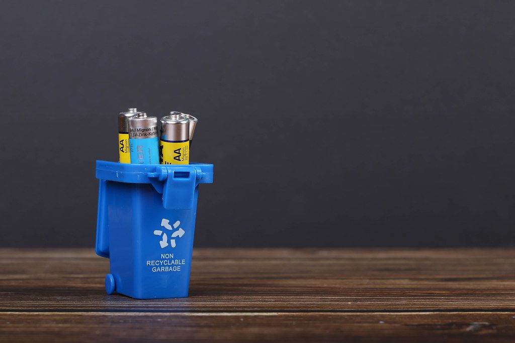 Batteries in blue recycle bin