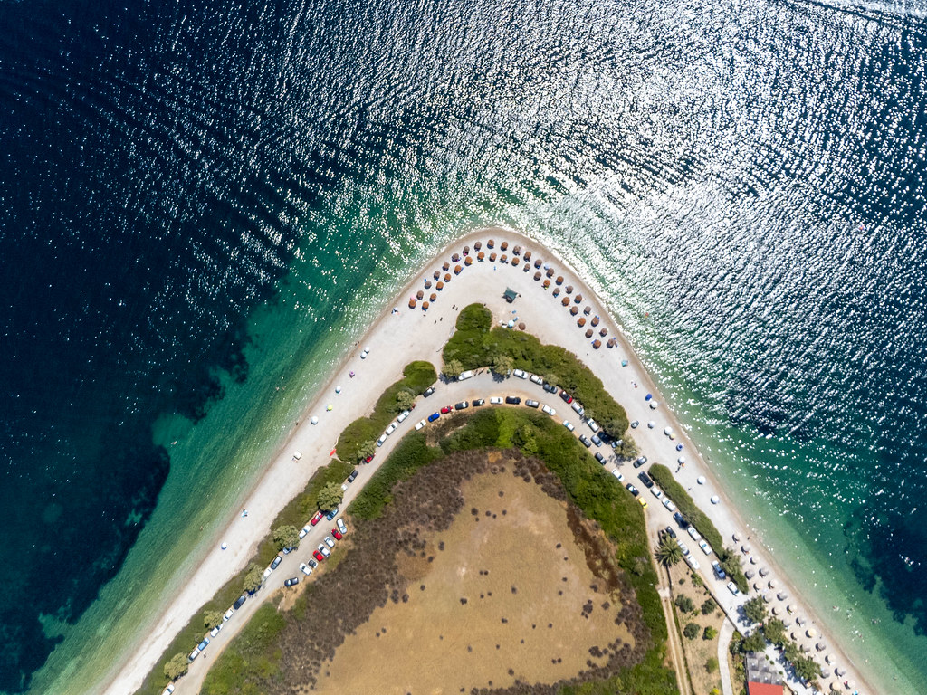 Beach with a horseshoe shape in Greece: overhead drone shot of Agios Dimitrios on Alonissos