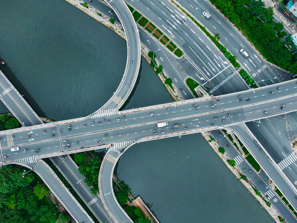 Bird View Drone Photo of Cars, Trucks and Motorbikes crossing a Bridge over Saigon River in Ho Chi Minh City, Vietnam