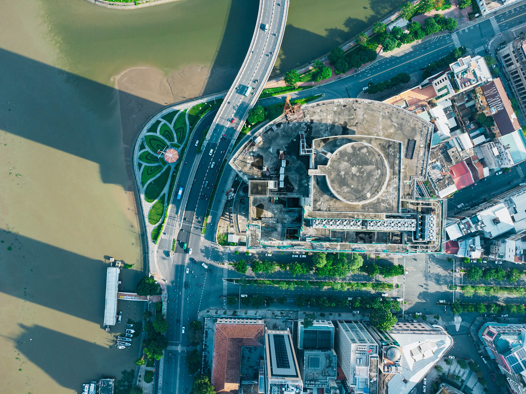 Bird View Drone Photo of the Rooftop of the unfinished and abandoned high-rise Building Saigon One Tower at the Saigon River next to Thu Ngu Flagpole in Ho Chi Minh City, Vietnam