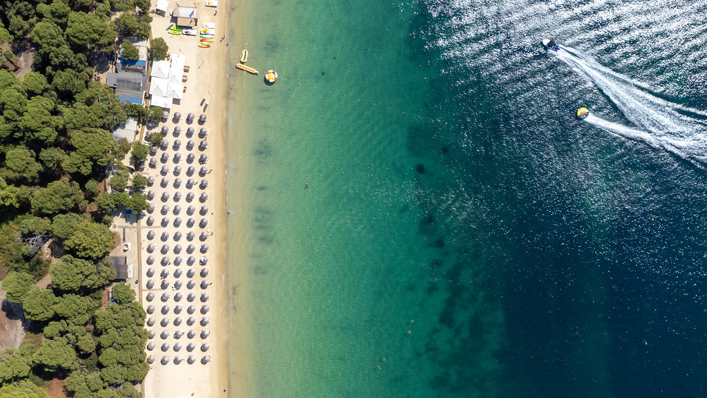Bird's eye view of famous Chrysi Ammos beach at Koukounaries with parasols and boats