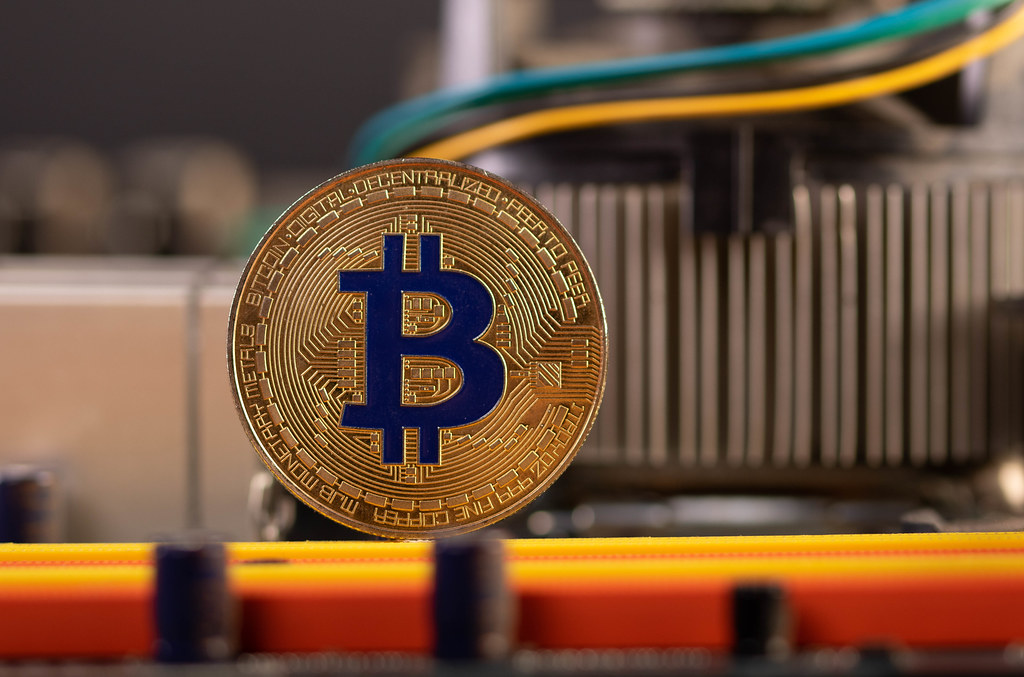 Bitcoin coin on computer parts background