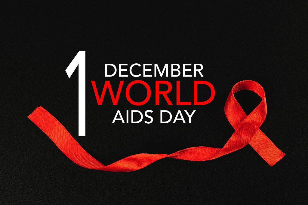 Black background with red ribbon and inscription World AIDS Day