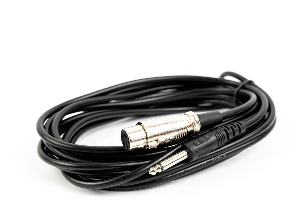 Black microphone cable with XLR connectors above white background