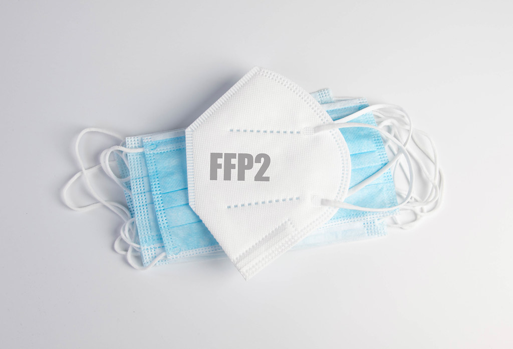 Blue medical face masks with FFP2 mask on white background