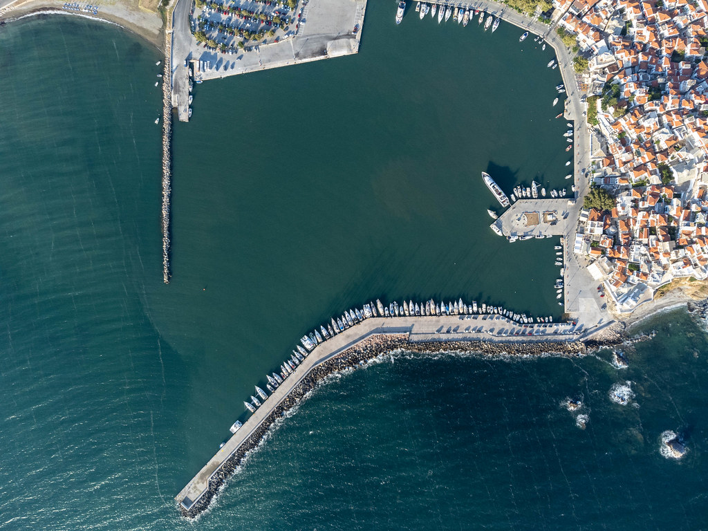 Boats lined up along the pier of Skopelos harbour. Bird's eye view