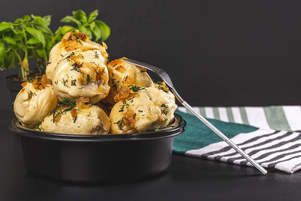 Boiled dumplings with herbs and fried onions