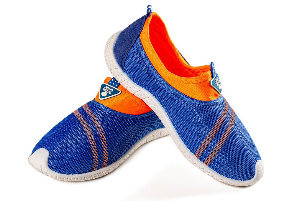 Boyish casual sports sneakers of blue-orange color on white background