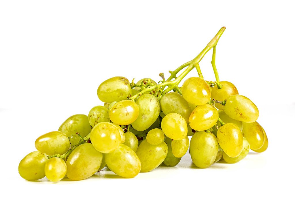 Branch of ripe sweet green grapes