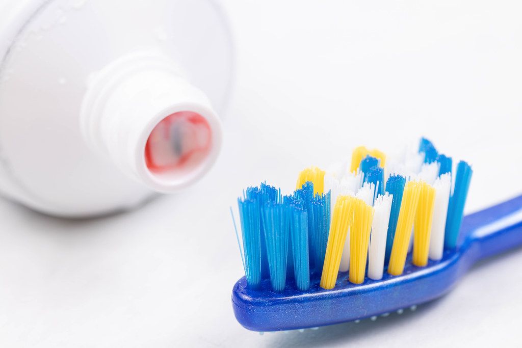 Brand new Toothbrush with Toothpaste above white background