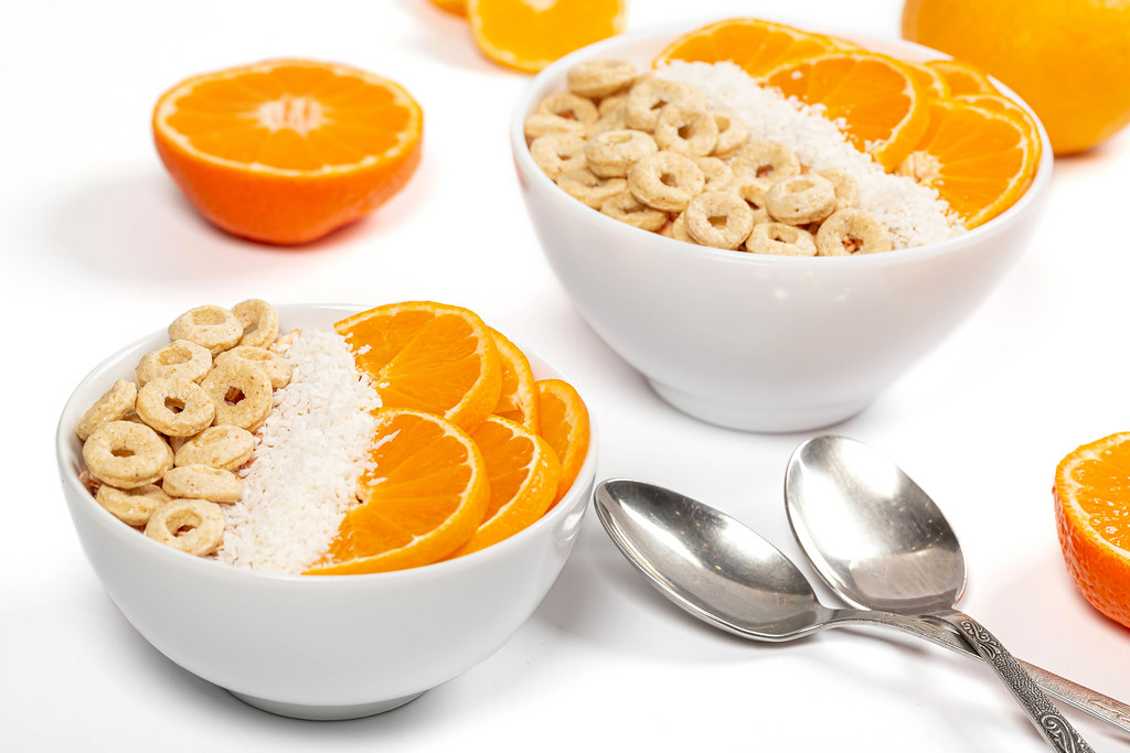 Breakfast background with fresh tangerines and coconut flakes