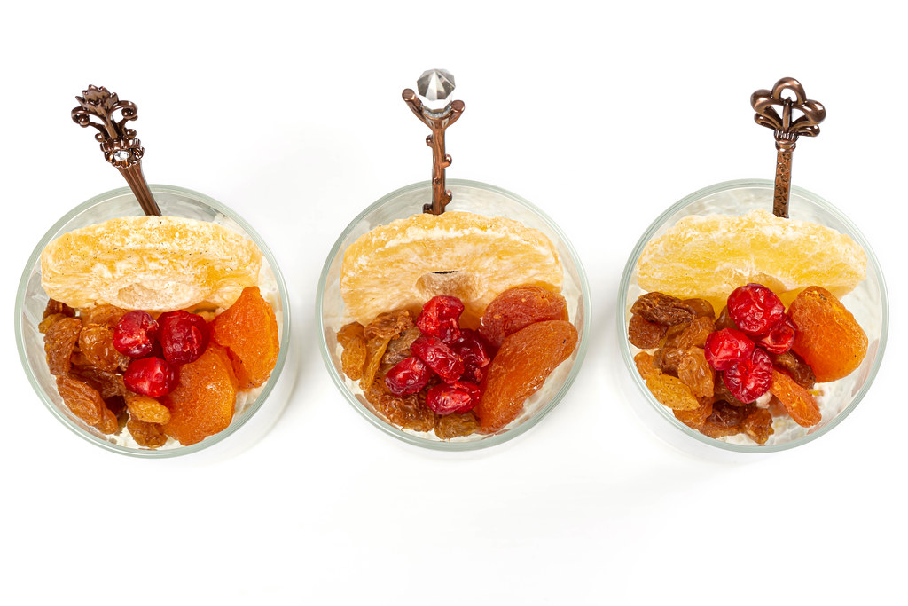 Breakfast from cottage cheese with dried apricots, raisins, dried cherries and pineapple in glasses