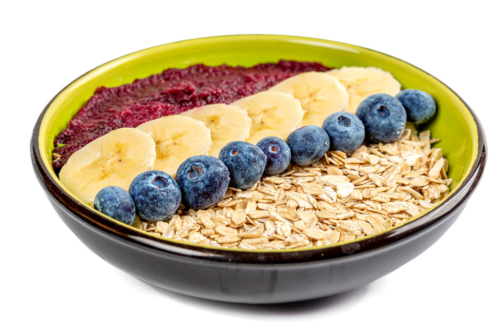 Breakfast oatmeal bowl with fresh fruit and plum puree