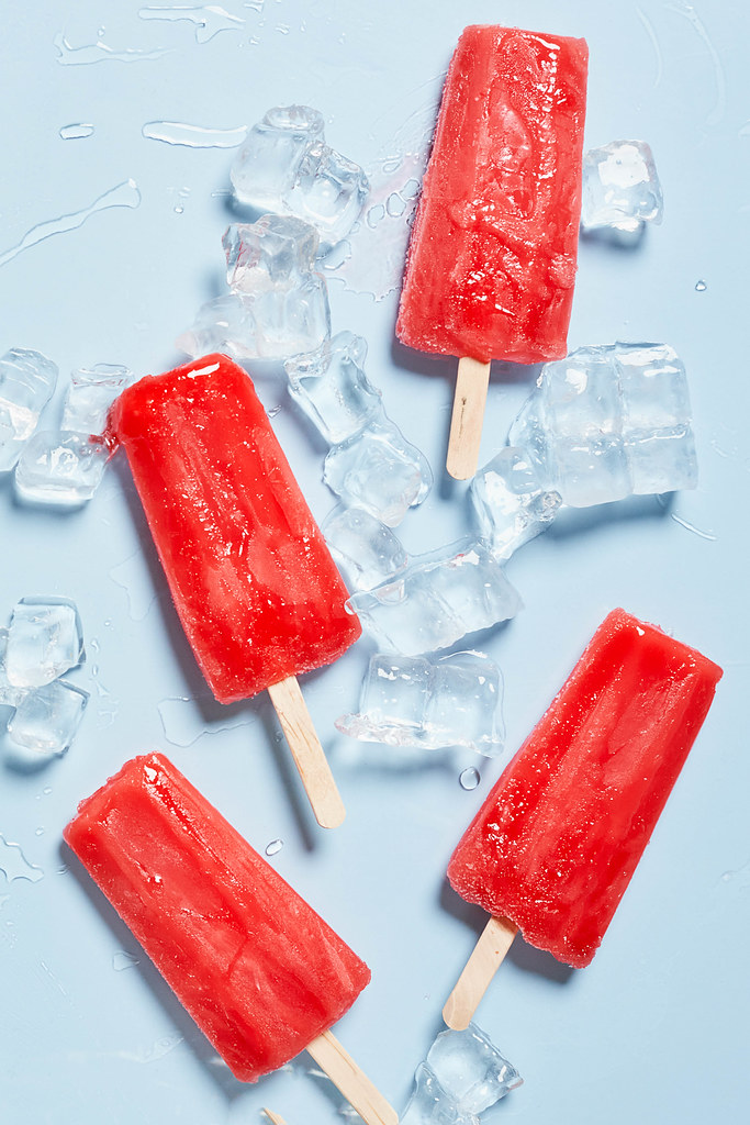 Bright popsicle made of sweet strawberries and ice cubes