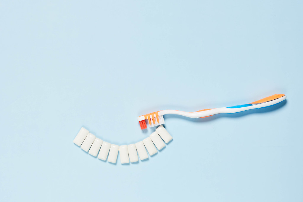 Brushing symbolic teeth with toothbrush