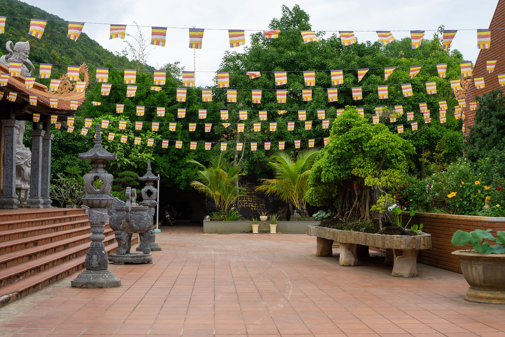 Buddhist Flags between two Pagoda Buildings in the Temple Complex of the Truc Lam Ho Quoc Zen Monastery in Phu Quoc, Vietnam