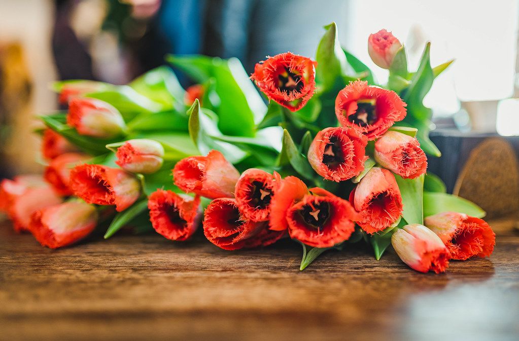 Bunch Of Red Tulips On The Wooden Table
