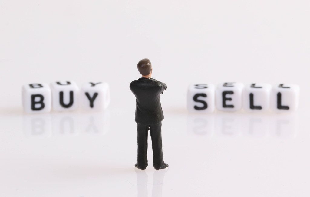 Businessman figure with Buy and Sell text