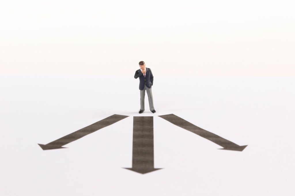 Businessman in front of decision which way to choose