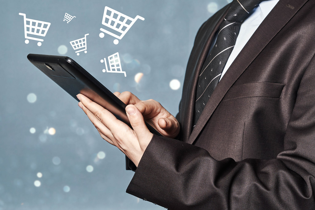 Businessman with a tablet. Online shopping and eCommerce concepts