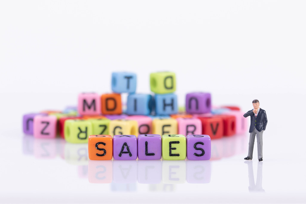 Businessman with colorful toy blocks with Sales text