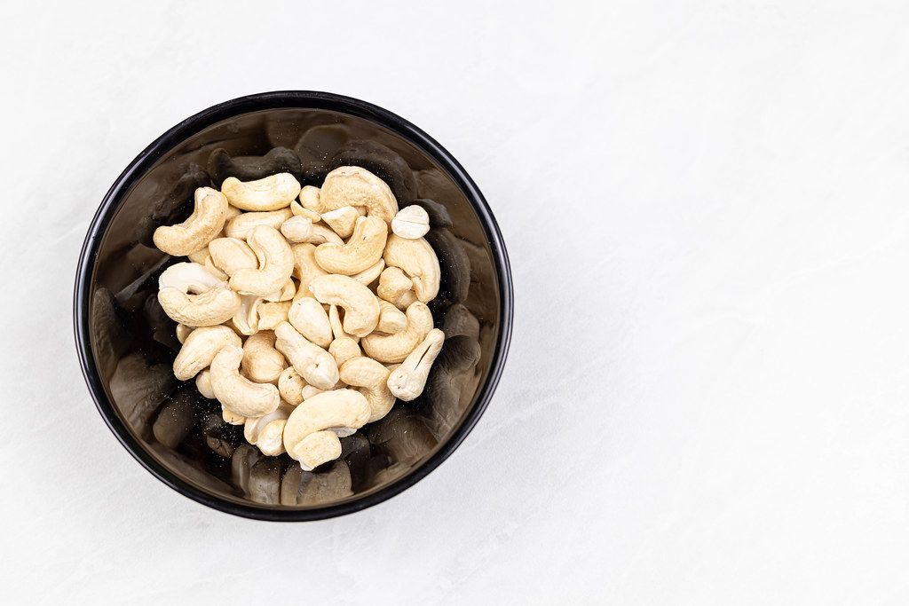 Cashew nuts in the bowl with copy space