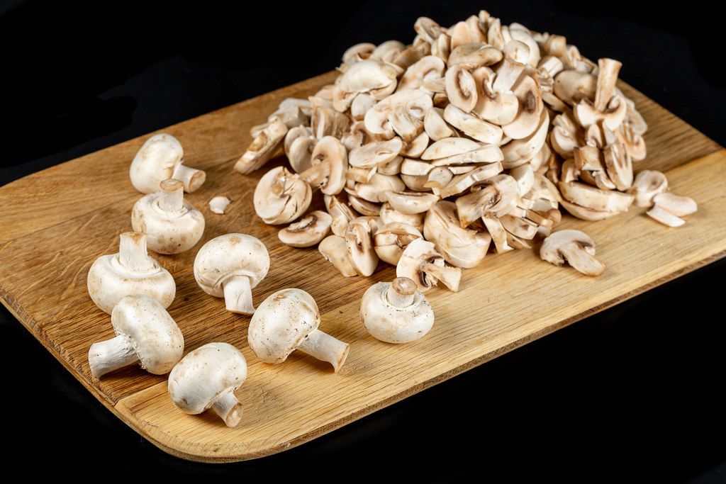 Champignon mushrooms on cutting board