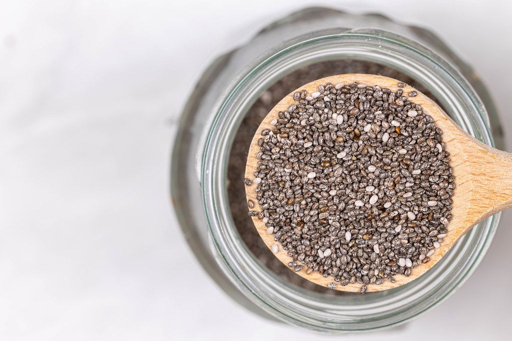 Chia Seeds on the wooden spoon with blurred background and copy space