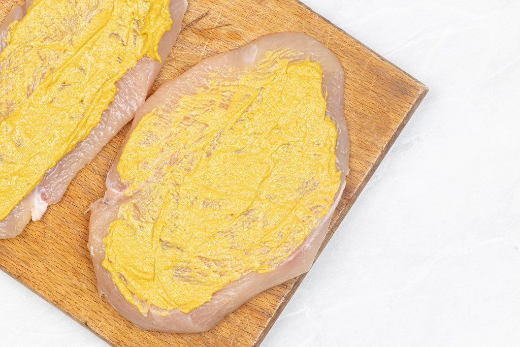 Chicken breasts coated with Mustard ready for frying