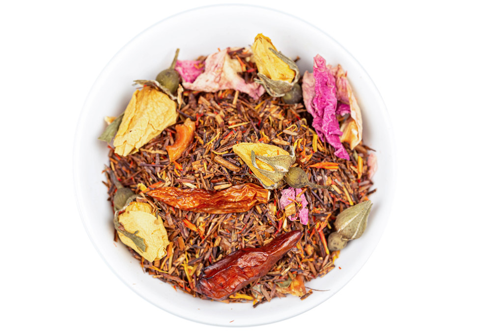 Chili tea with yellow and pink rosebuds, top view