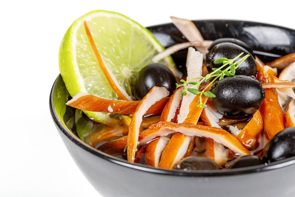 Chinese soup with smoked chicken fillet, vegetables and black olives