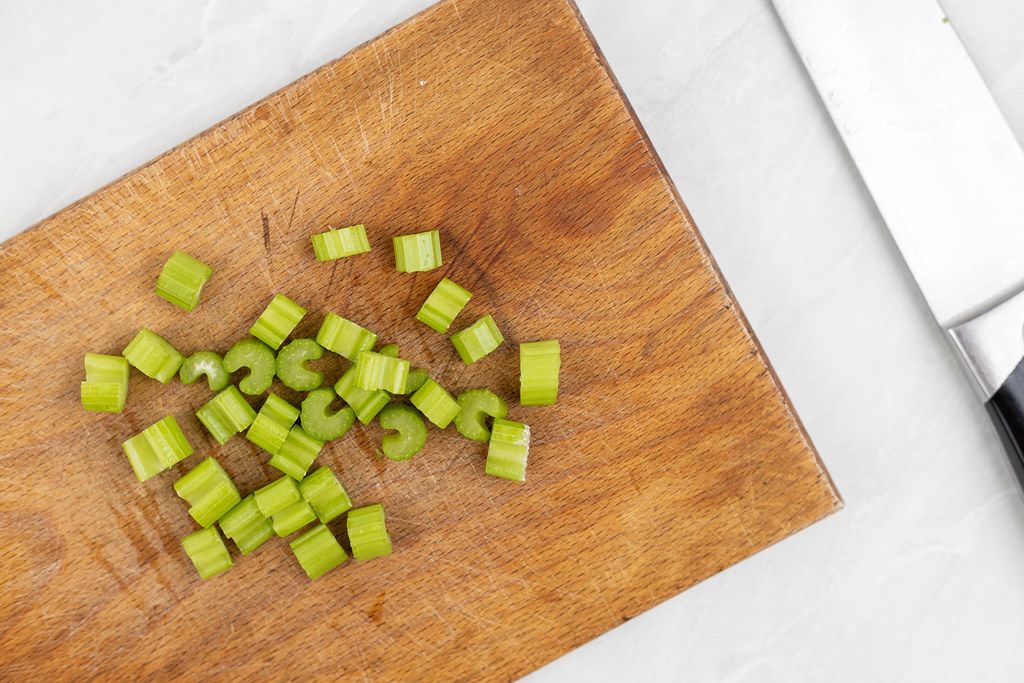 Chopped Celery on the wooden cutting board