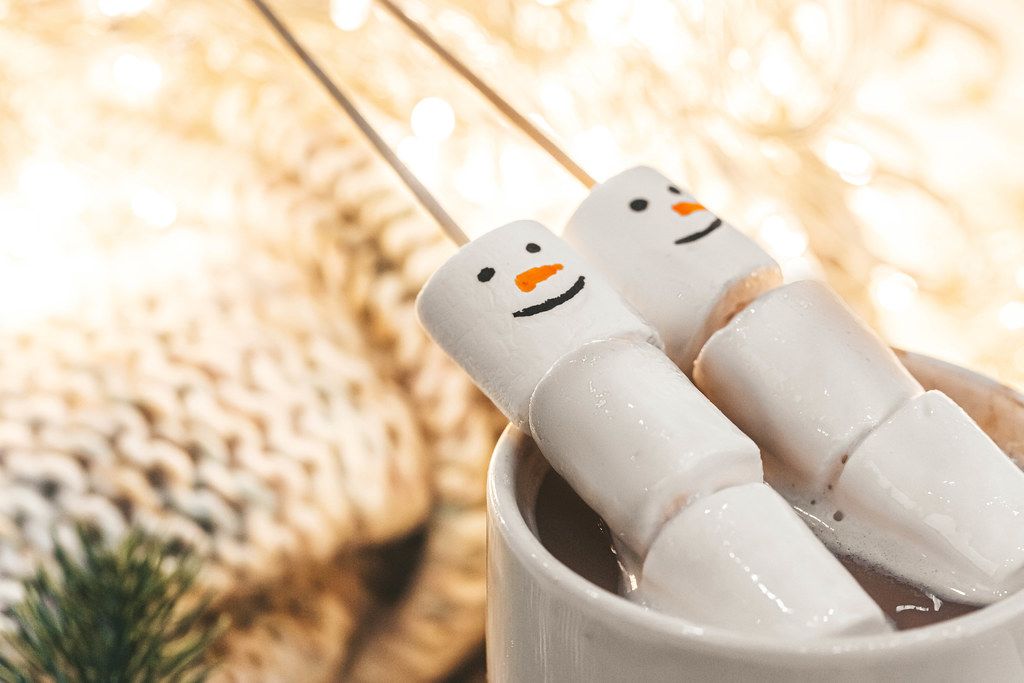 Christmas background with coffee and marshmallow snowmen