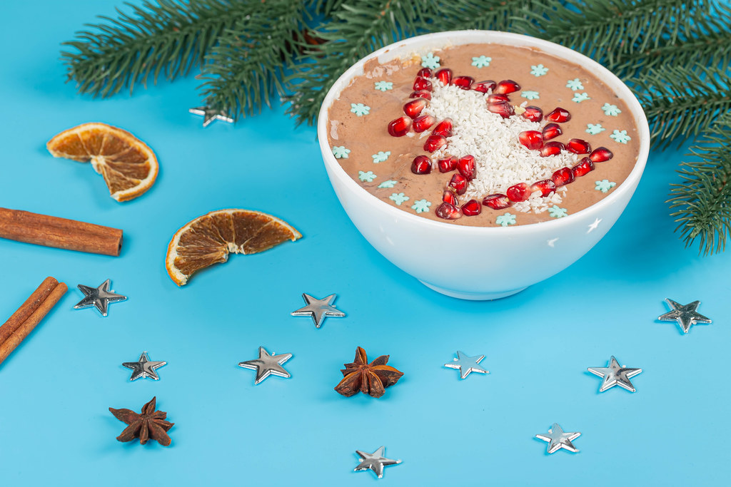 Christmas blue background with a bowl of festive oatmeal