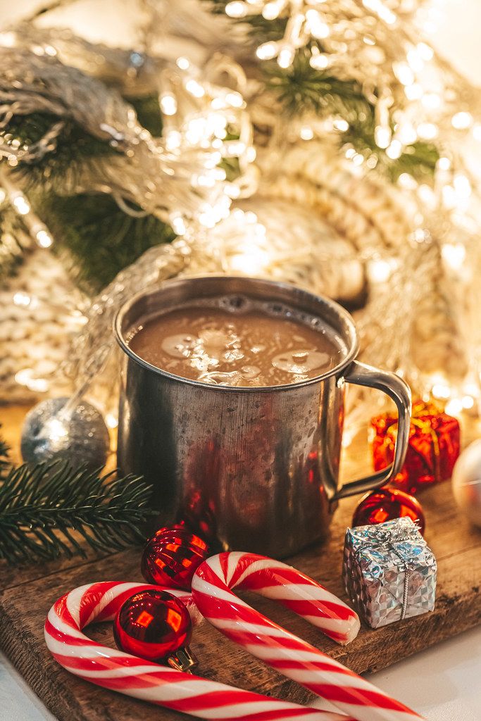 Christmas evening background with hot cocoa and glowing garland