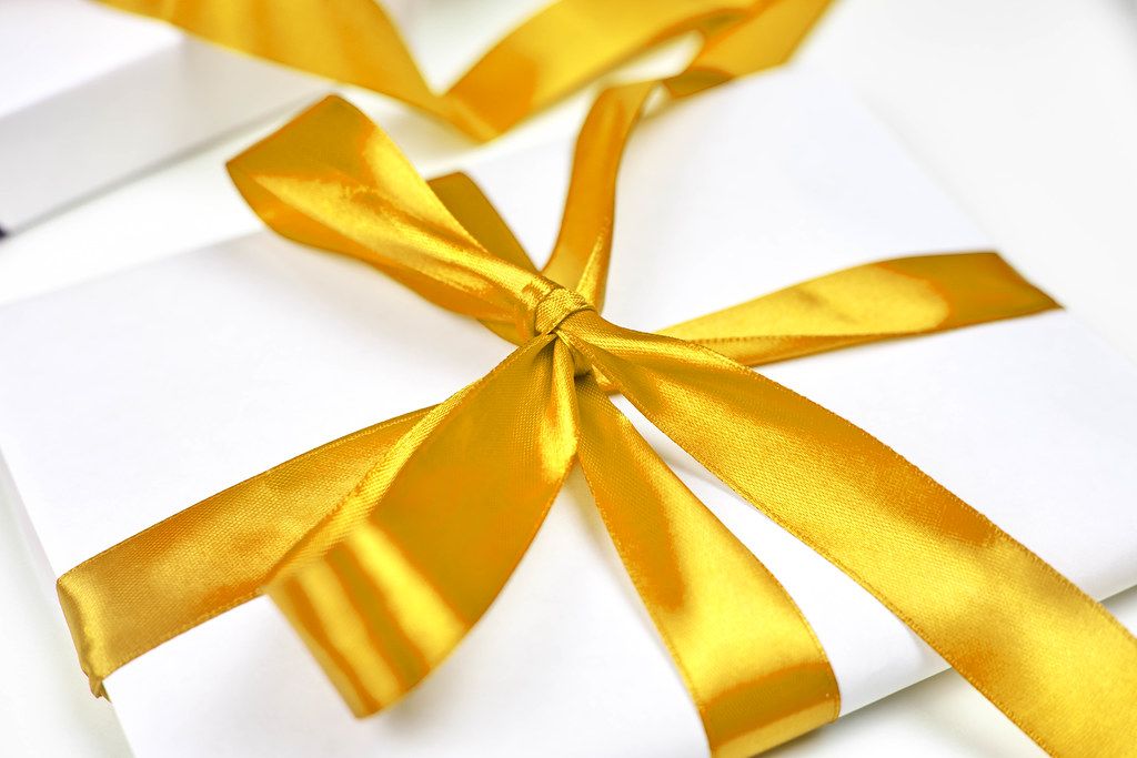 Christmas gift with beautiful yellow textile ribbon