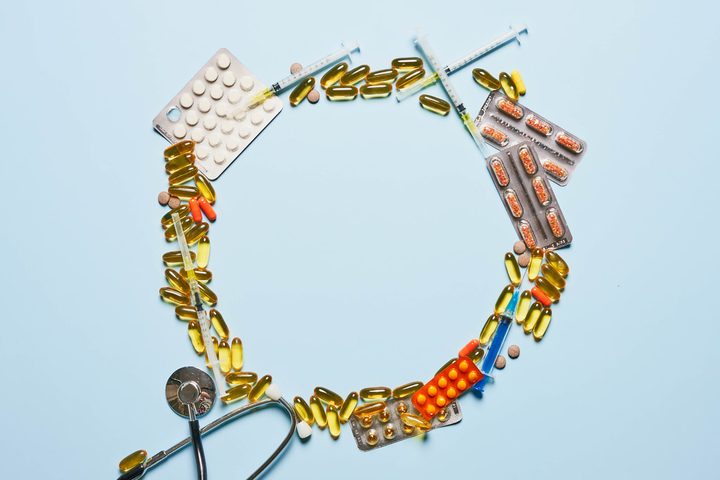 Circle made of medical pills and capsules with copy space in the center