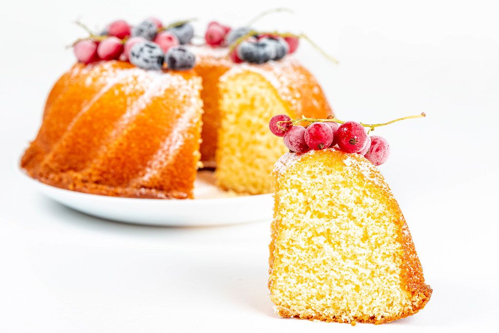 Close-up, a piece of yellow cake with red currant berries