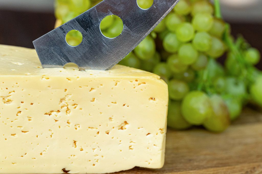 Close-up, cheese with a cheese knife