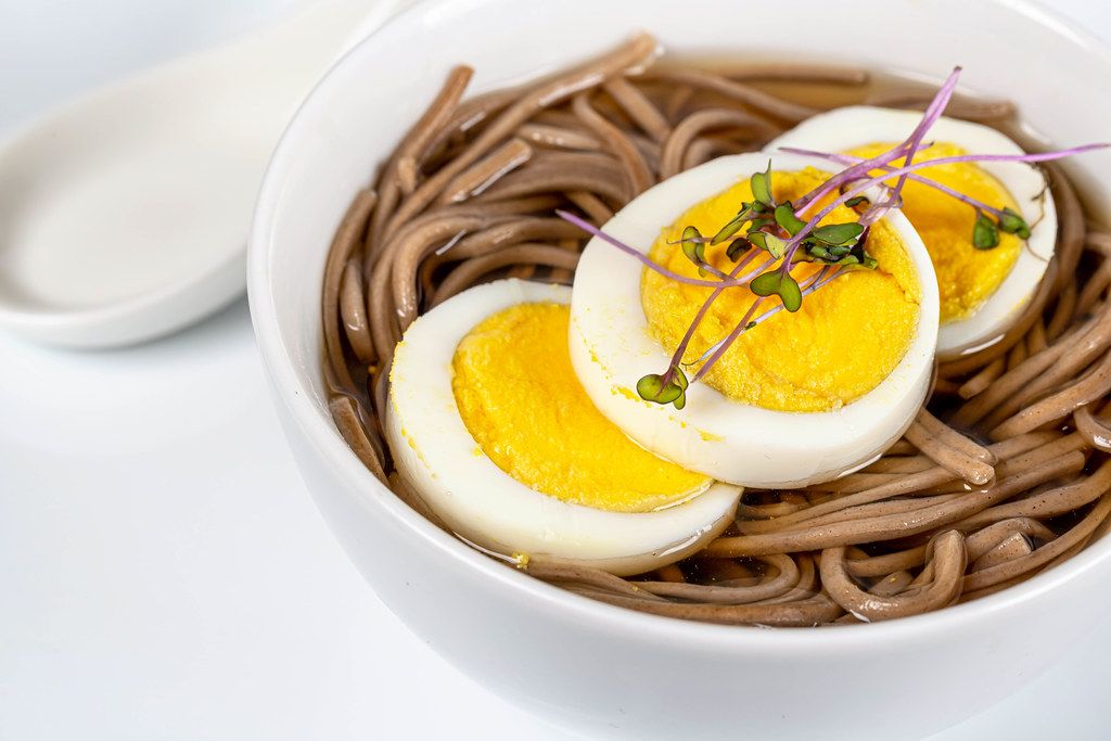 Close up, Chinese soup with brown noodles and chicken egg