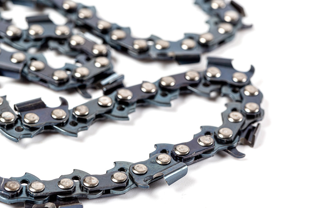 Close-up, electric saw chain on white