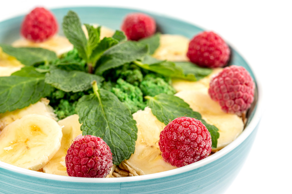 Close-up, oatmeal with bananas, raspberries and mint leaves
