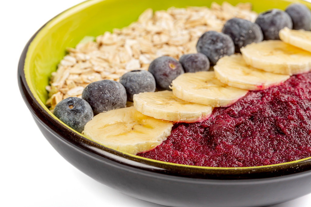 Close-up, oatmeal with plum puree, blueberries and banana