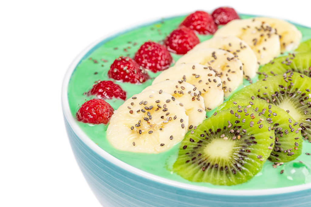 Close-up of delicious oatmeal with yogurt, banana, kiwi, raspberry and chia seeds