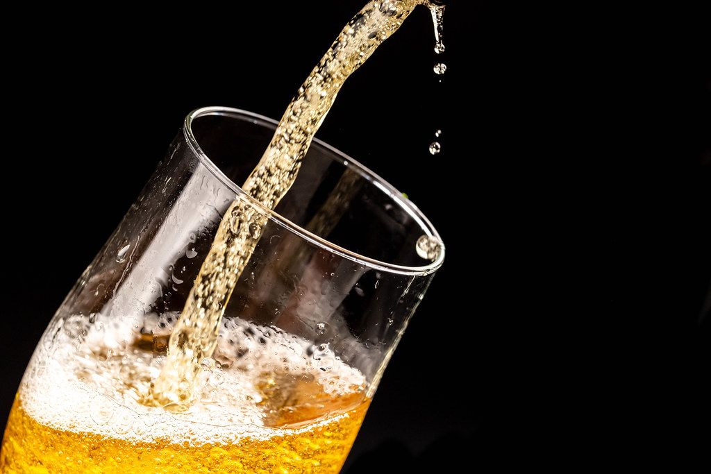 Close-up of light beer with bubbles and splashes