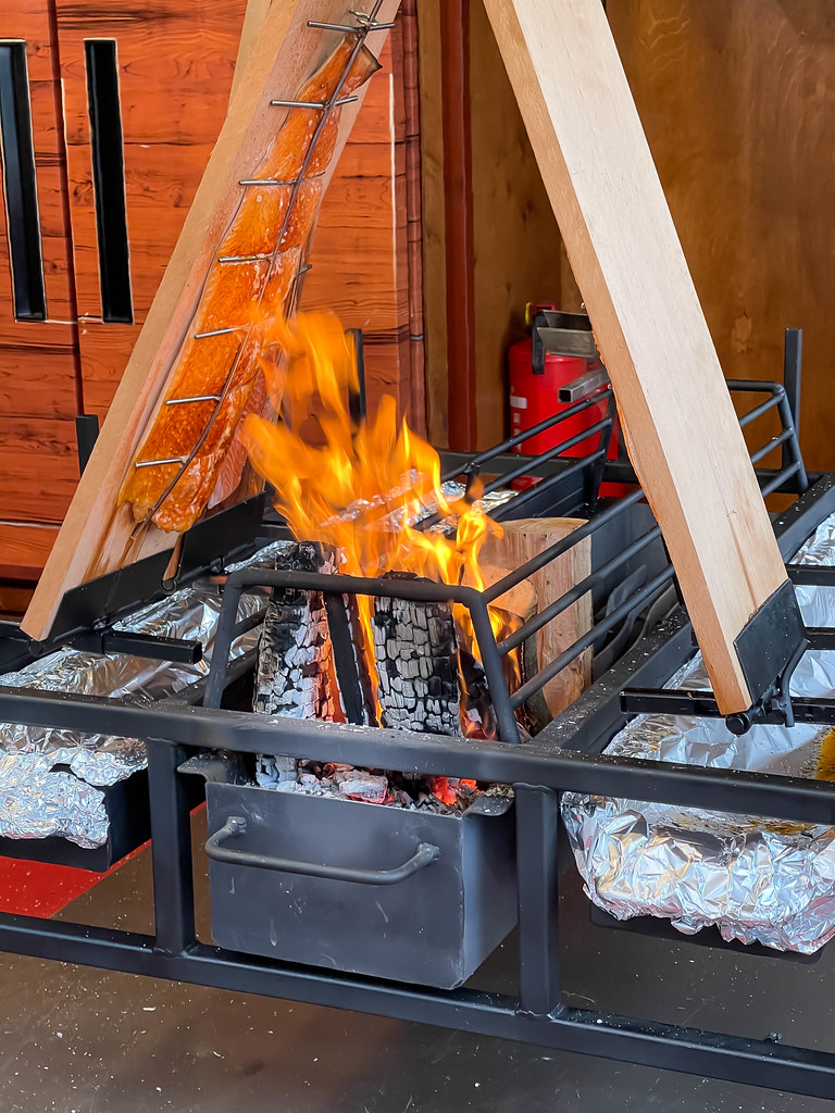 Close-up of salmon being cooked over open fire according to the Finnish tradition