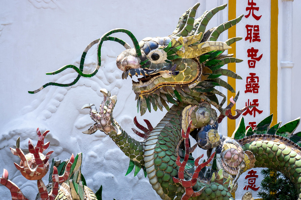 Close Up Photo of a Dragon Statue with Many Ornaments with Chinese Letters in the Background at the Phuc Kien Pagoda in the Old Town of Hoi An, Vietnam