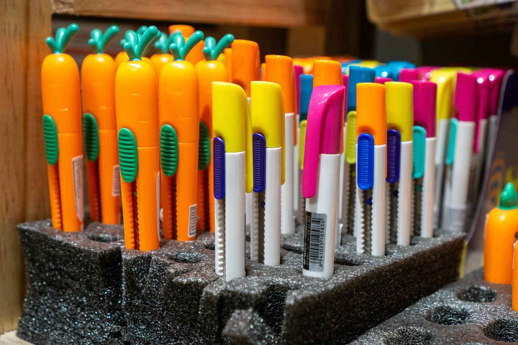 Close Up Photo of Colorful and Carrot Shaped Cutting Knives in a Styrofoam Display at a Stationery Store