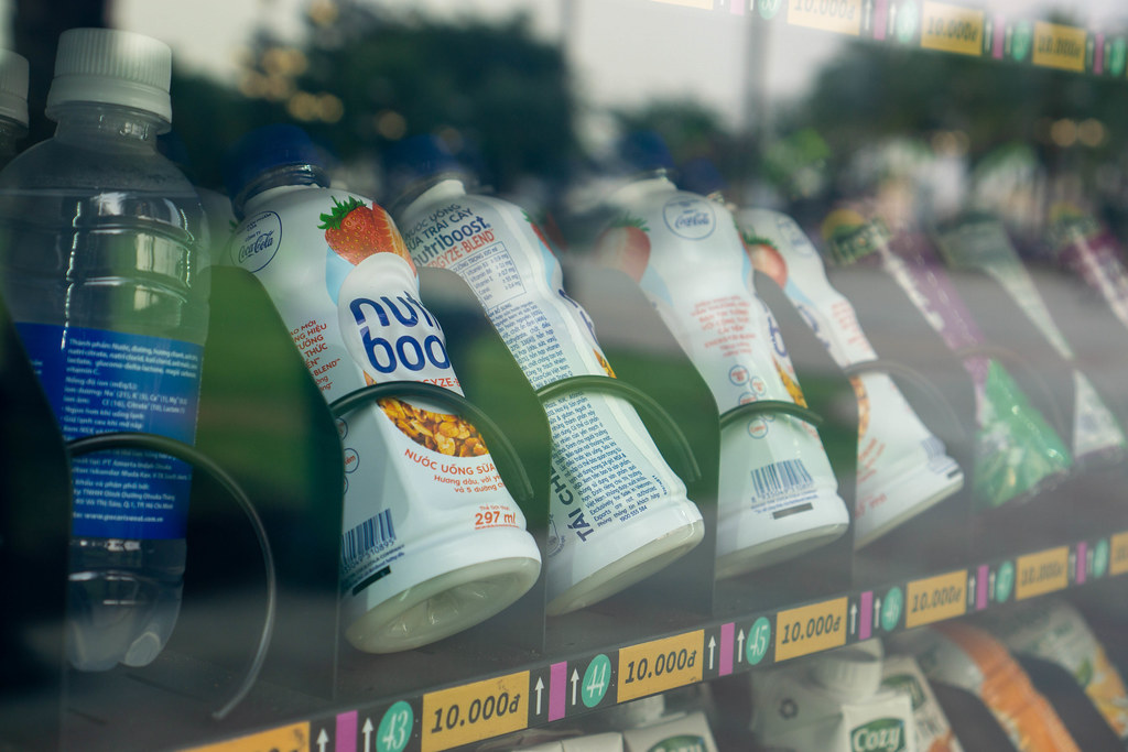 Close Up Photo of Different Cold Drinks in an Automatic Vending Machine with Price Tags and Numbers in a Public Park